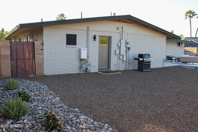 202 N Florence Ave, Litchfield Park, AZ 85340 - back of property featuring brick siding, a gate, and a patio