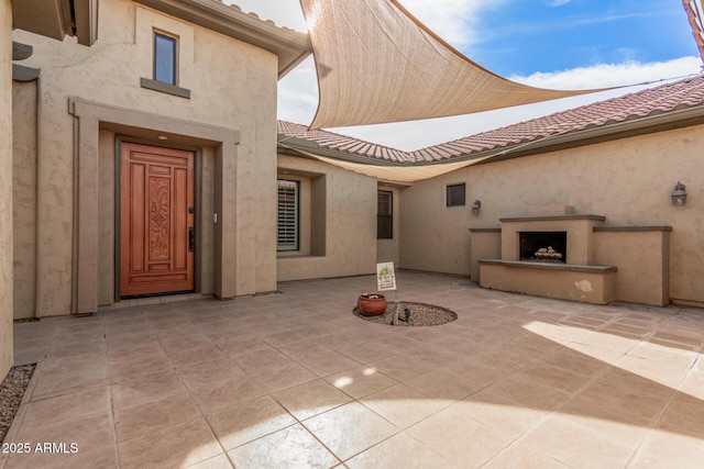 exterior space featuring an outdoor fireplace