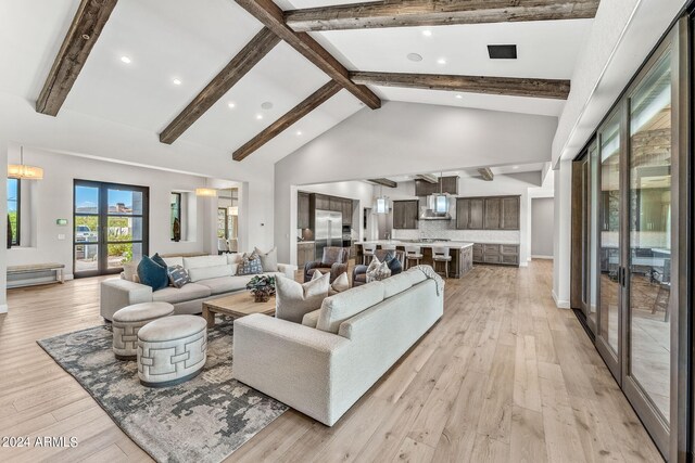 living room featuring high vaulted ceiling, beam ceiling, and light hardwood / wood-style flooring