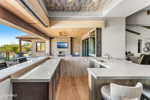 view of patio / terrace with an outdoor kitchen, ceiling fan, and sink