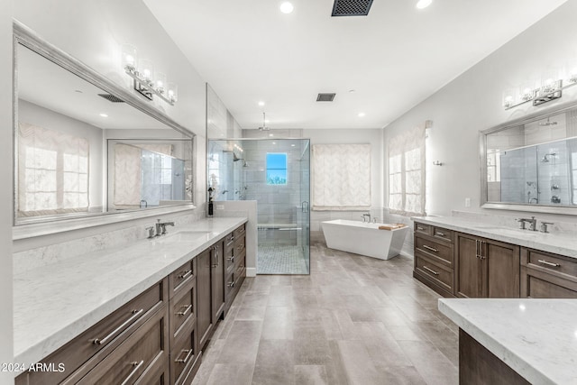 bathroom featuring vanity, plus walk in shower, and plenty of natural light