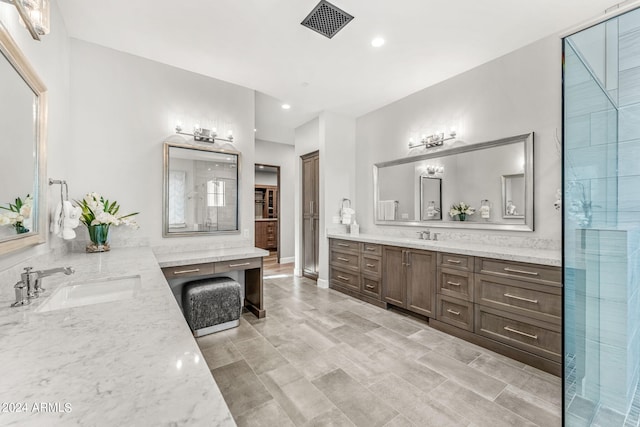 bathroom featuring walk in shower and vanity