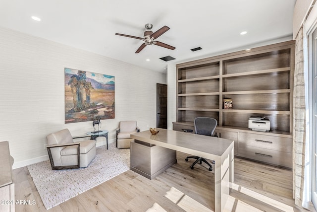 office area with light hardwood / wood-style floors and ceiling fan