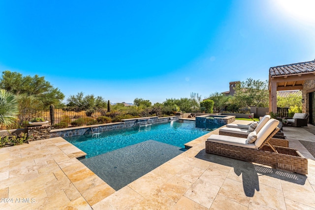 view of pool featuring a patio, pool water feature, and an in ground hot tub