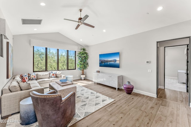 living room featuring vaulted ceiling, ceiling fan, and light hardwood / wood-style flooring