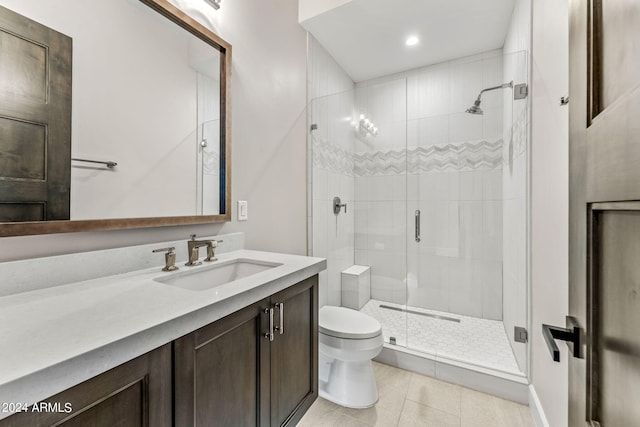 bathroom featuring vanity, tile patterned floors, toilet, and a shower with door