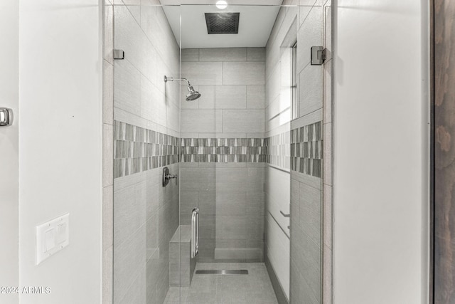 bathroom with a shower with shower door