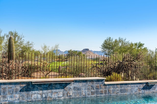 view of swimming pool with a mountain view