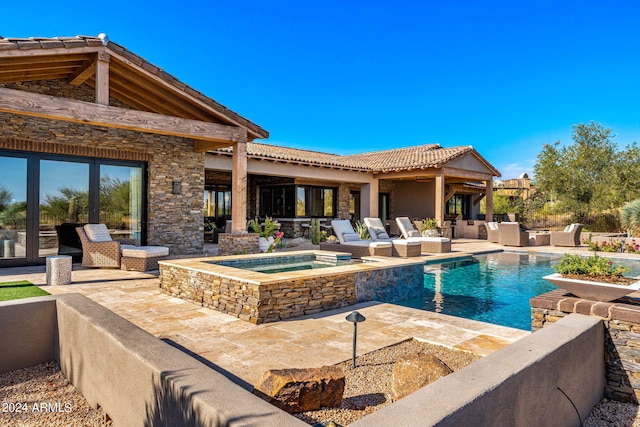 view of pool with a patio area, outdoor lounge area, ceiling fan, and an in ground hot tub