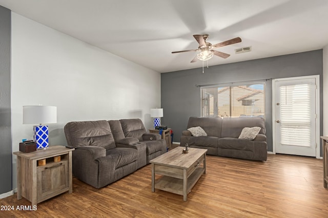 living room with baseboards, ceiling fan, visible vents, and wood finished floors