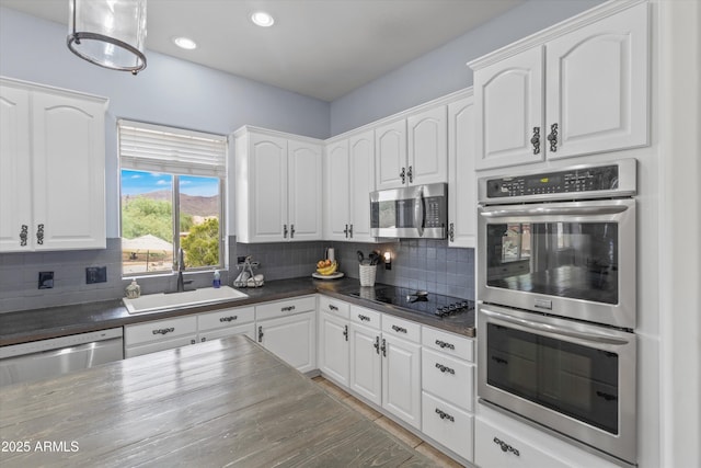3019 W Trail Dr, Phoenix, AZ 85086 - kitchen with white cabinets, a sink, backsplash, and appliances with stainless steel finishes