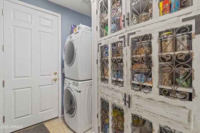 3019 W Trail Dr, Phoenix, AZ 85086 - washroom featuring stacked washing maching and dryer, light tile patterned floors, and laundry area