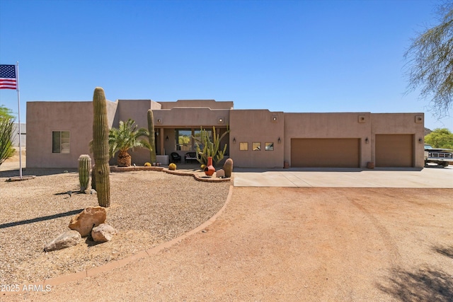 3019 W Trail Dr, Phoenix, AZ 85086 - pueblo-style house featuring stucco siding, an attached garage, and concrete driveway