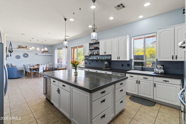 3019 W Trail Dr, Phoenix, AZ 85086 - kitchen with dark countertops, tasteful backsplash, a sink, and visible vents