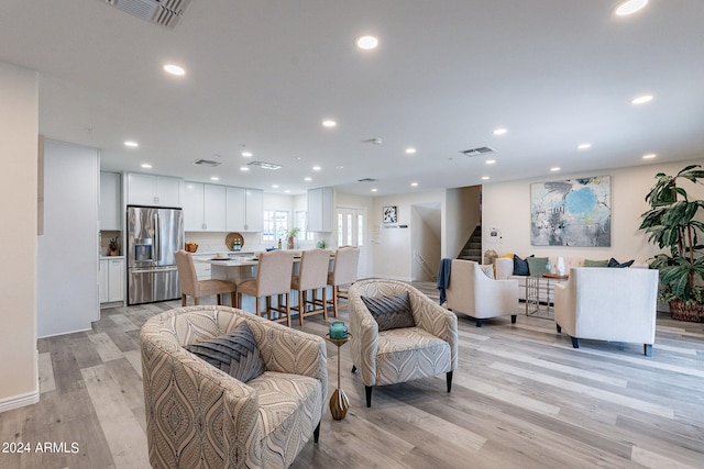 living room with recessed lighting, stairway, light wood finished floors, and visible vents