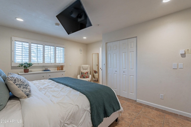 tiled bedroom with a closet