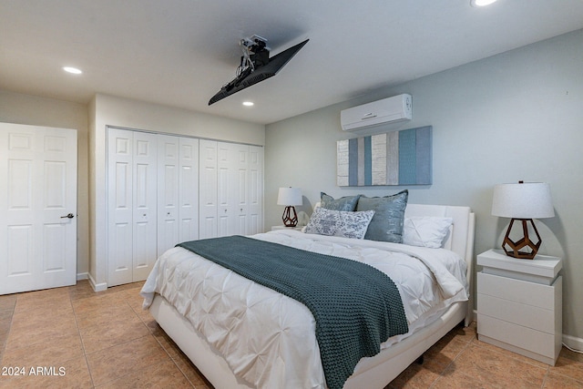 tiled bedroom featuring an AC wall unit, a closet, and ceiling fan