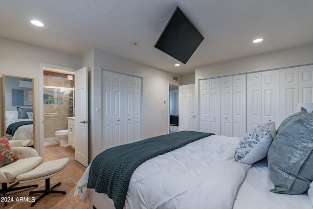 bedroom with two closets, visible vents, connected bathroom, and recessed lighting