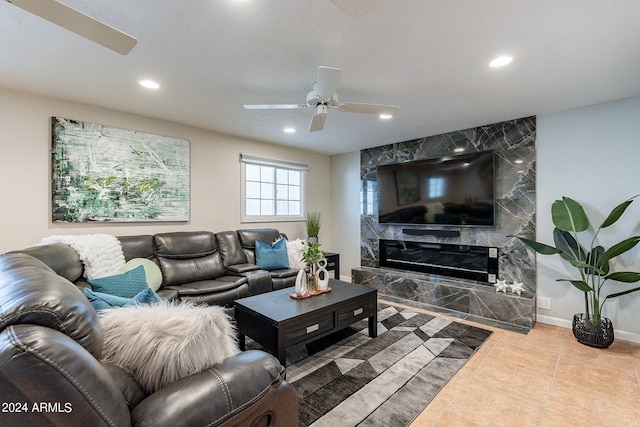 living area featuring a premium fireplace, baseboards, tile patterned floors, recessed lighting, and a ceiling fan
