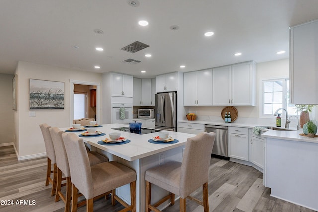 dining area featuring light hardwood / wood-style flooring and sink