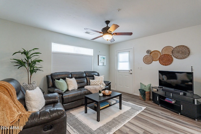 living area with light wood-type flooring, a ceiling fan, and visible vents