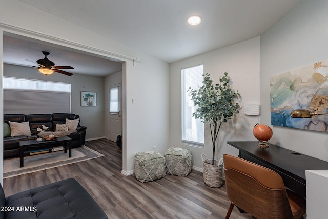 sitting room featuring baseboards, ceiling fan, and wood finished floors