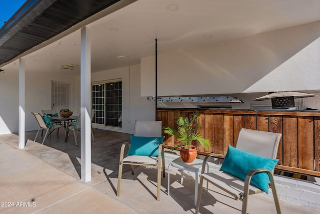 view of patio featuring outdoor dining area and fence