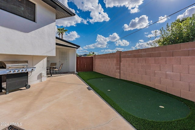 view of patio with a fenced backyard and area for grilling