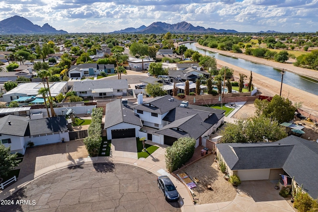 birds eye view of property with a water and mountain view and a residential view