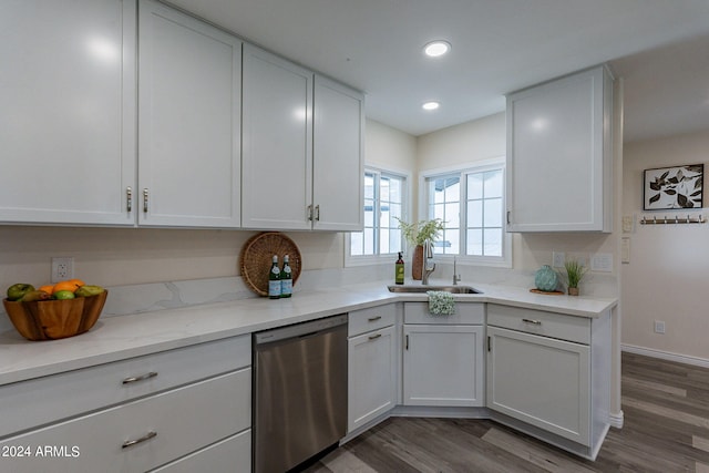 kitchen with light wood finished floors, a sink, recessed lighting, and dishwasher