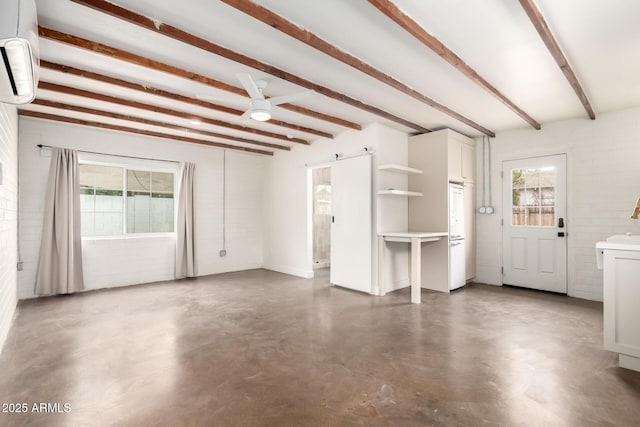 unfurnished living room with beam ceiling, a barn door, and an AC wall unit