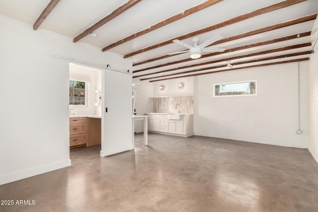 interior space featuring ceiling fan and a barn door