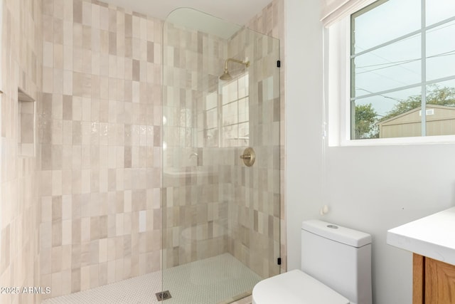 bathroom featuring toilet and an enclosed shower