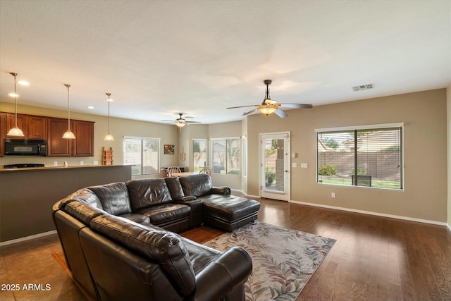 living area featuring dark wood finished floors, a ceiling fan, baseboards, recessed lighting, and visible vents