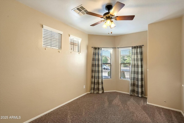 spare room with visible vents, a ceiling fan, carpet, and baseboards