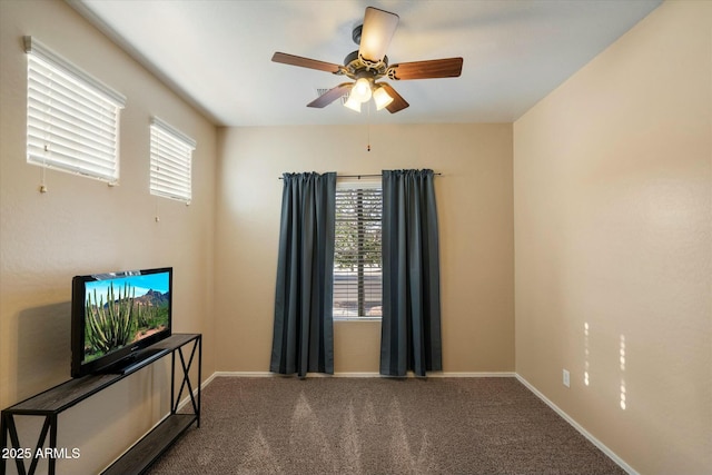 carpeted empty room with baseboards and ceiling fan