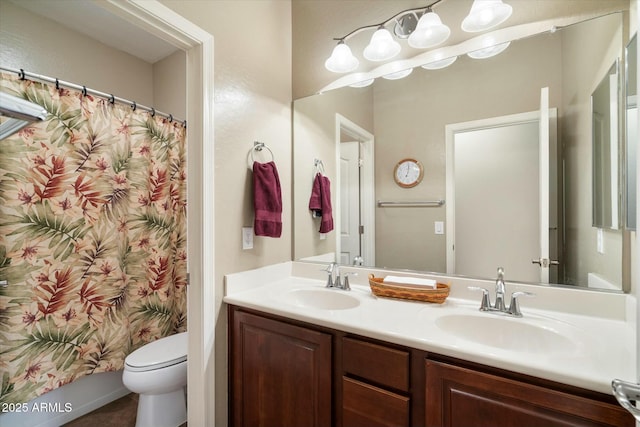 full bathroom featuring a sink, toilet, double vanity, and a shower with shower curtain