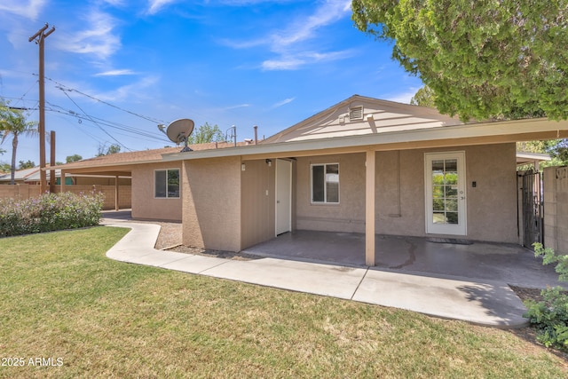 101 W 8th Pl, Mesa, AZ 85201 - rear view of house with stucco siding, fence, a lawn, and a patio