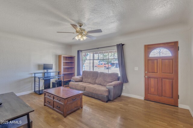101 W 8th Pl, Mesa, AZ 85201 - living room featuring baseboards, light wood finished floors, ceiling fan, and a textured ceiling