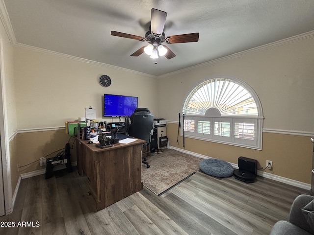 office space featuring ceiling fan, baseboards, wood finished floors, and crown molding