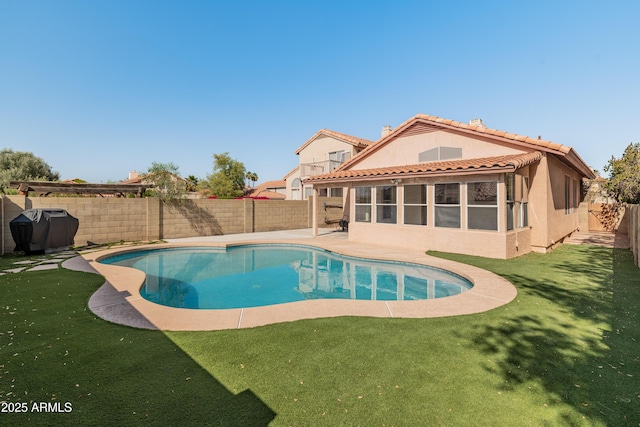 view of pool with a grill, a yard, a fenced backyard, and a fenced in pool