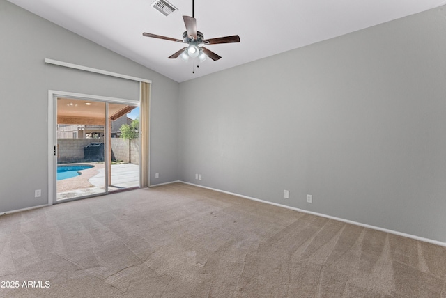 empty room with carpet flooring, visible vents, and ceiling fan