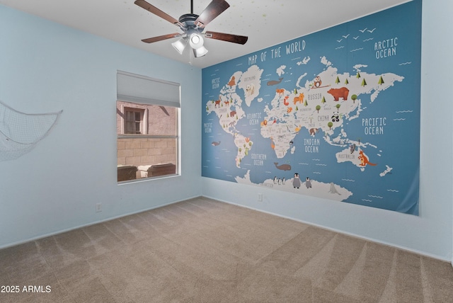 unfurnished room featuring carpet flooring, baseboards, and a ceiling fan