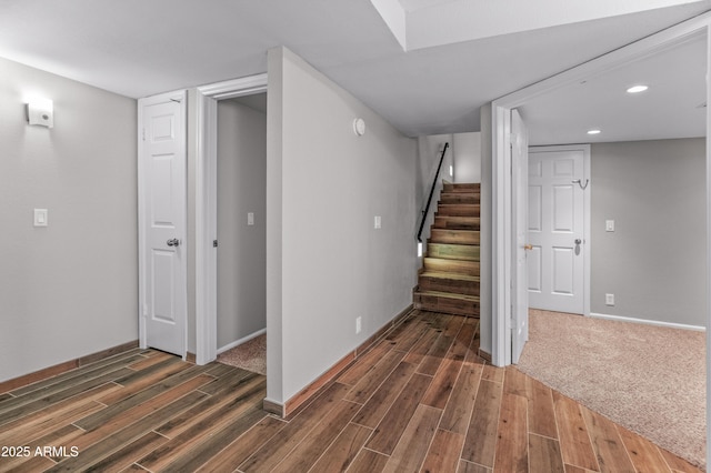 finished basement with recessed lighting, baseboards, stairway, and wood finished floors