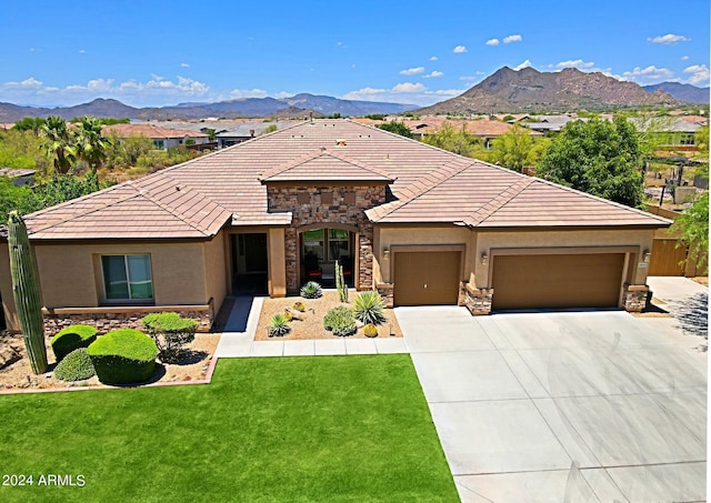 view of front facade with stone siding, stucco siding, and a mountain view