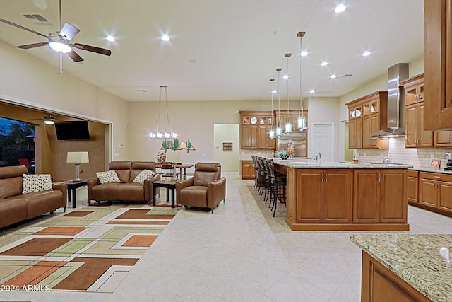 living room featuring recessed lighting, visible vents, light tile patterned floors, and ceiling fan with notable chandelier