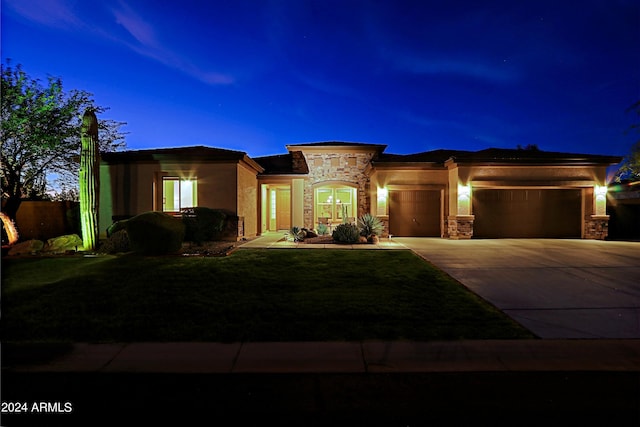 view of front of home with concrete driveway, stucco siding, a lawn, a garage, and stone siding