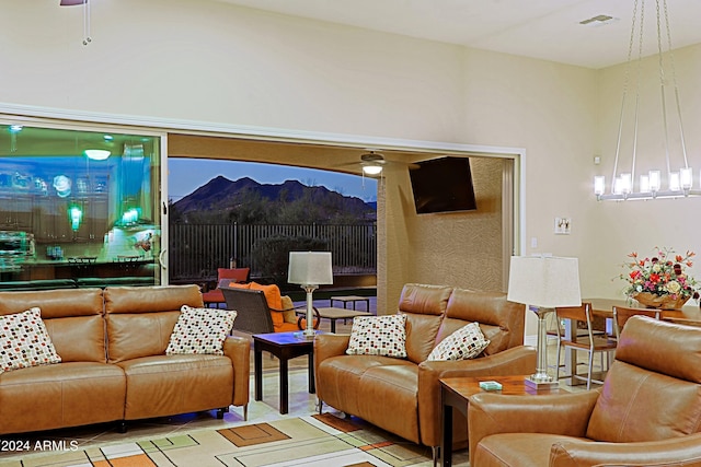 living area with visible vents and ceiling fan