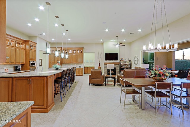 dining room featuring a glass covered fireplace, recessed lighting, and ceiling fan