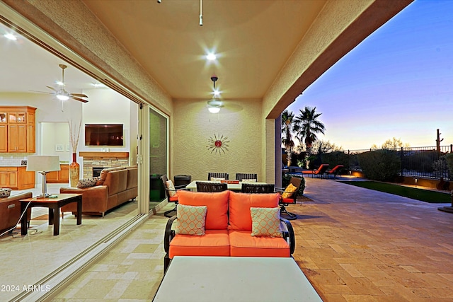 view of patio / terrace featuring outdoor dining space, fence, and an outdoor hangout area